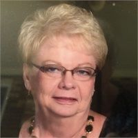 A close up of a woman wearing glasses and a necklace.