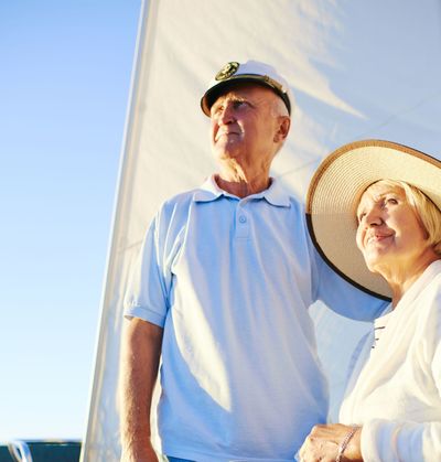 A man wearing a hat stands next to a woman wearing a hat