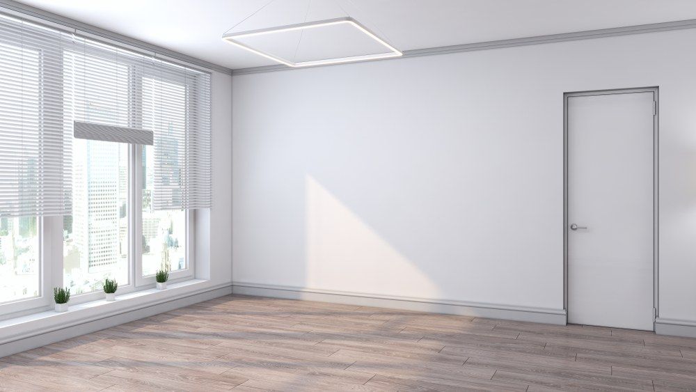 A Man in an Orange Shirt and Hat is Plastering a Wall — Clean Line Plastering in Pacific Palms, NSW