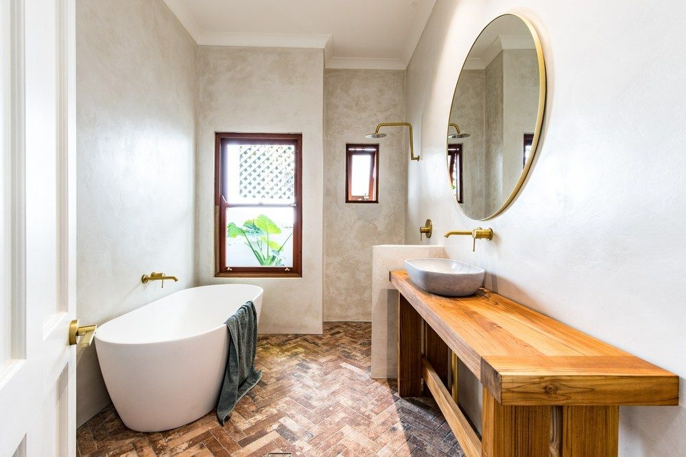 A Bathroom With a Bathtub, Sink, Mirror and Window — Clean Line Plastering in Forster - Tuncurry, NSW
