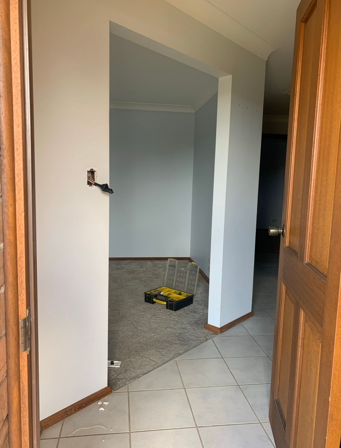 A Person is Using a Trowel to Plaster a Wall — Clean Line Plastering in Forster - Tuncurry, NSW