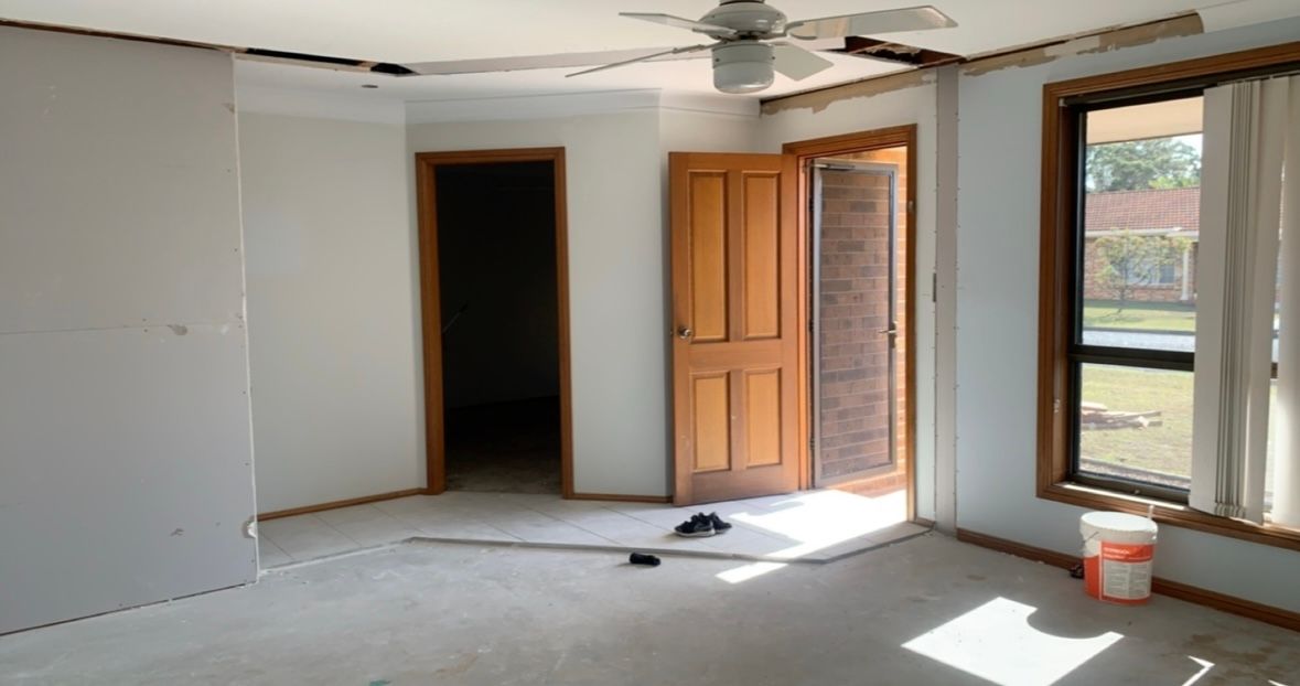 An Empty Room With a Wall Made of Drywall and a Concrete Floor — Clean Line Plastering in Forster - Tuncurry, NSW
