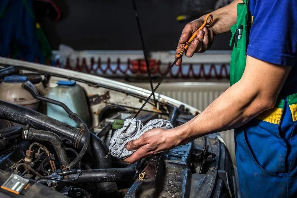 Experienced Mechanic Checking Engine Oil In Canberra