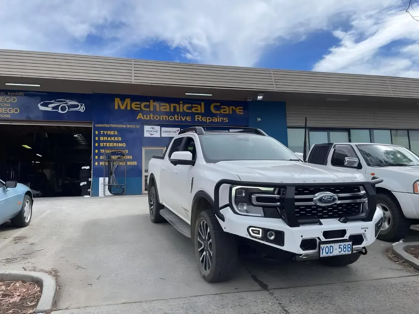 White Truck With Black Accents Parked in Front of Mechanical Care Automotive Shop — Mechanical Care in Belconnen, ACT