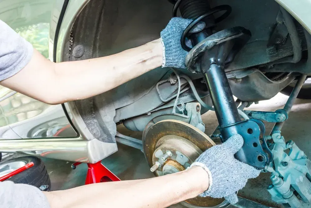 Mechanic Replacing a Car Shock Absorber — Mechanical Care in Belconnen, ACT