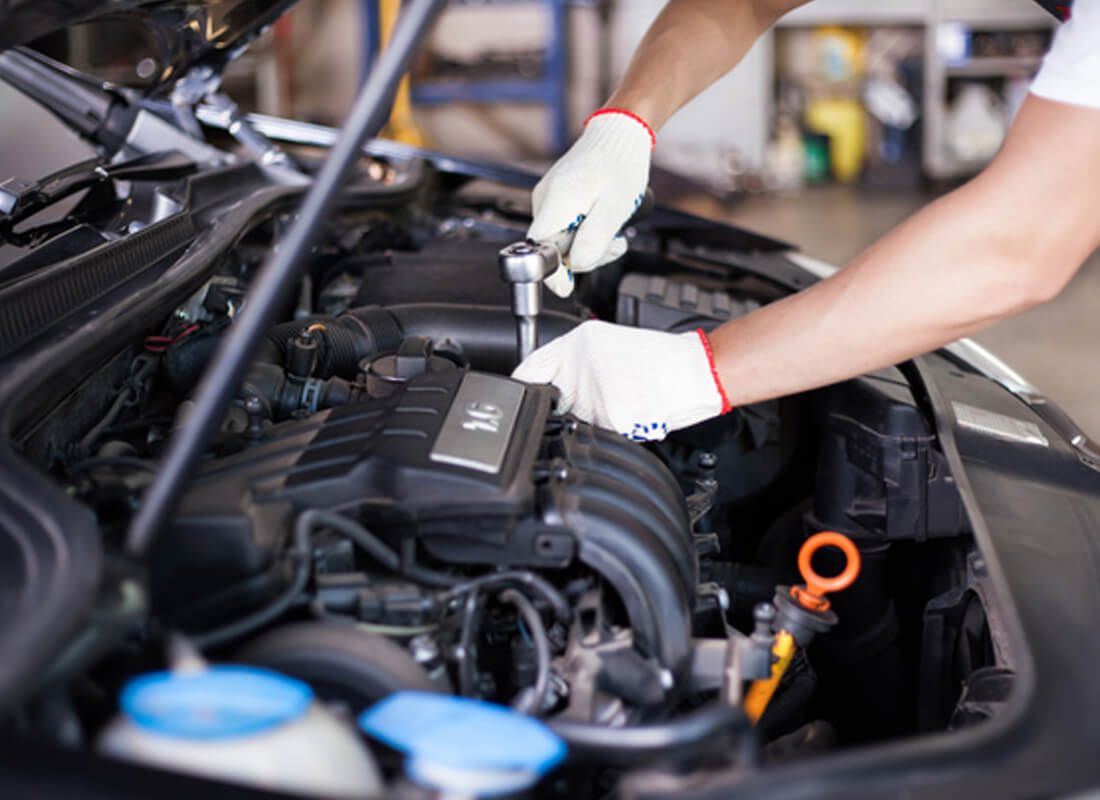 Mechanic Belconnen Performing Engine Maintenance In Automotive Workshop