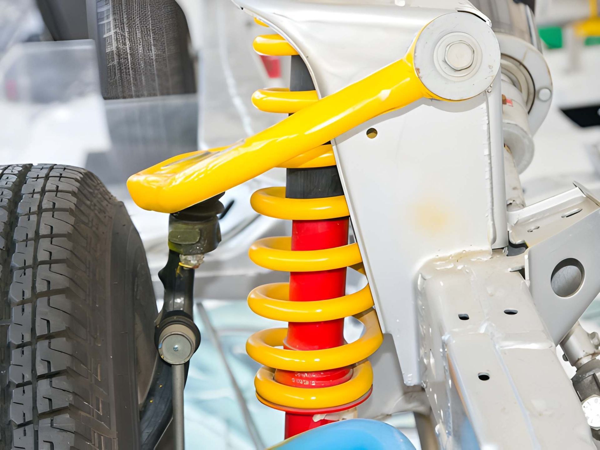 Yellow Coil Spring and Shock Absorber on a Car's Suspension System — Mechanical Care in Belconnen, ACT