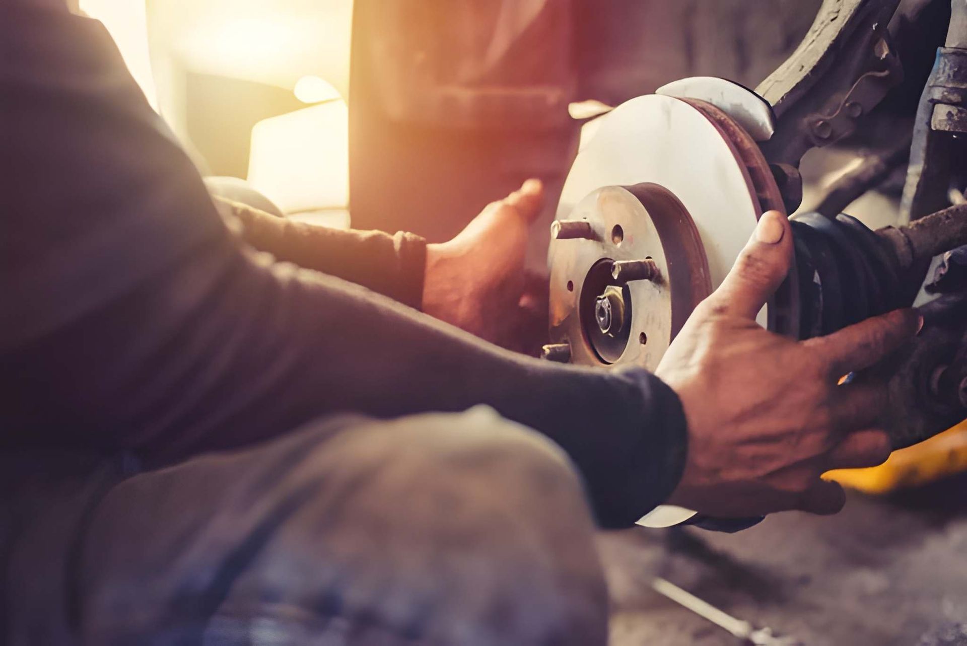 Mechanic Working on Car Brake Rotor in a Garage — Mechanical Care in Belconnen, ACT