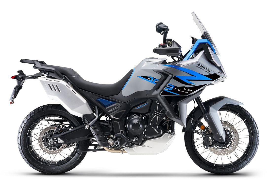 Gray and blue adventure motorcycle on a white background, equipped for off-road riding.