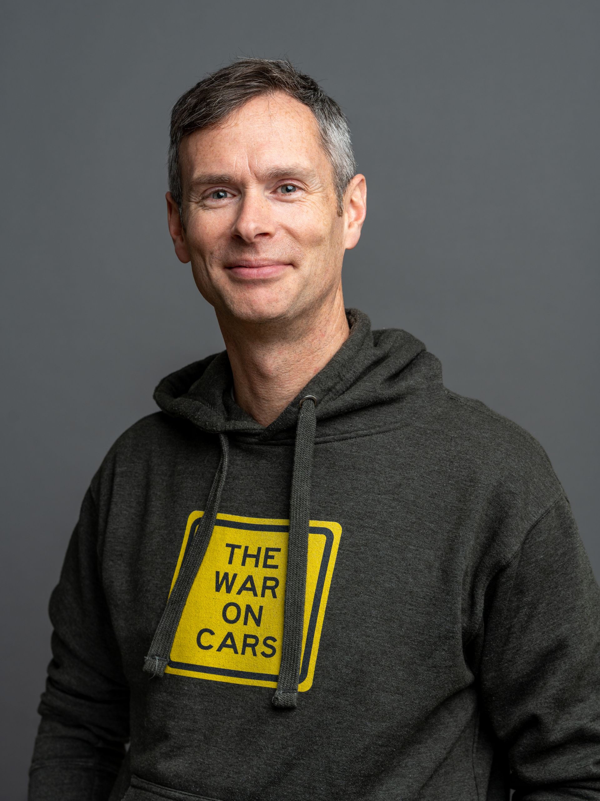 Man wearing a gray hoodie with 