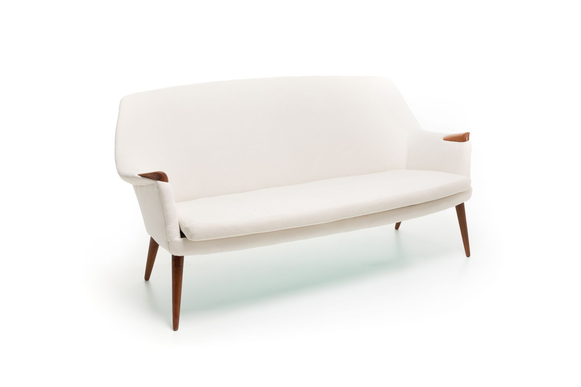 White mid-century modern sofa with wooden legs and armrests, against a white background.