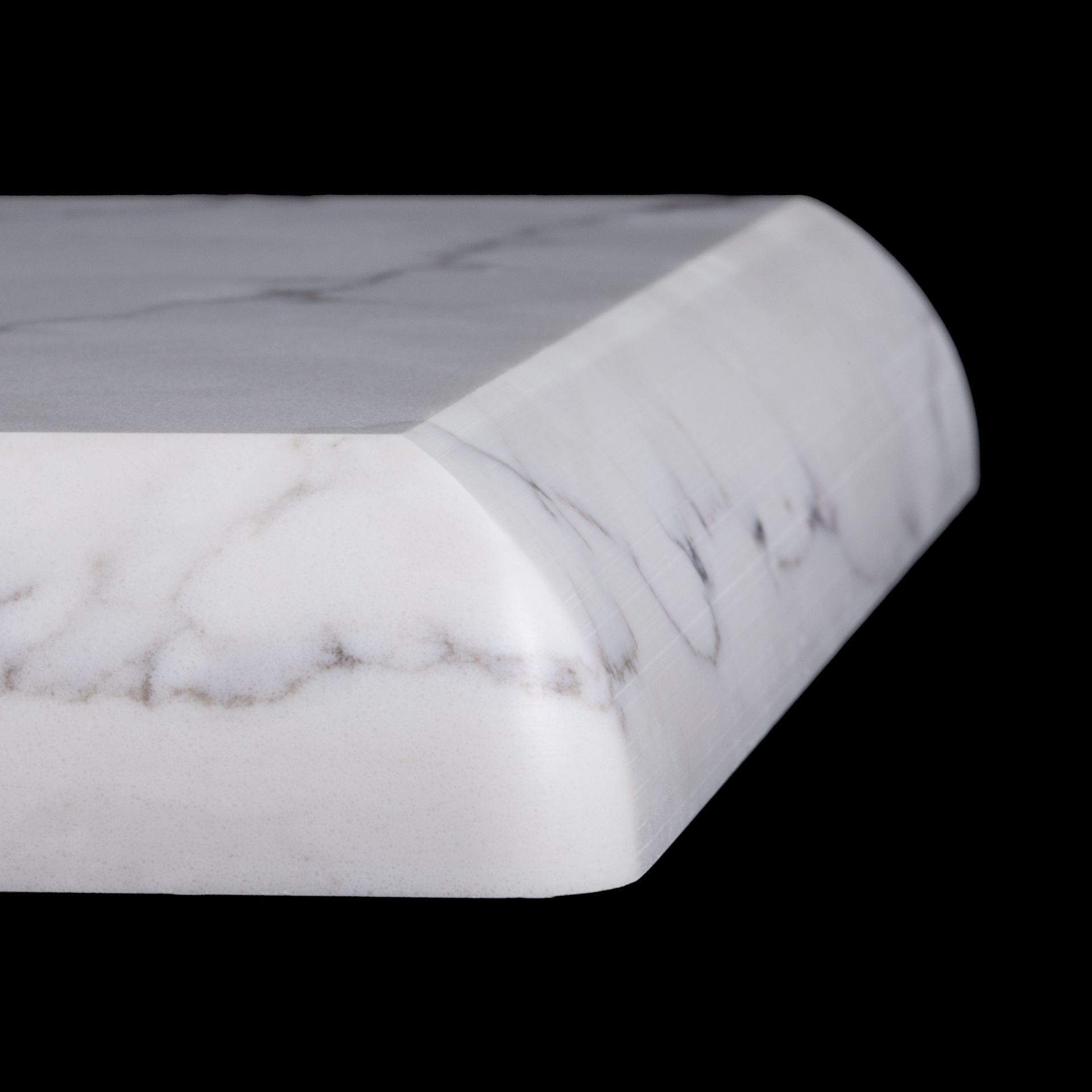 White countertop with marble pattern, featuring an edge with a beveled corner and curved top.