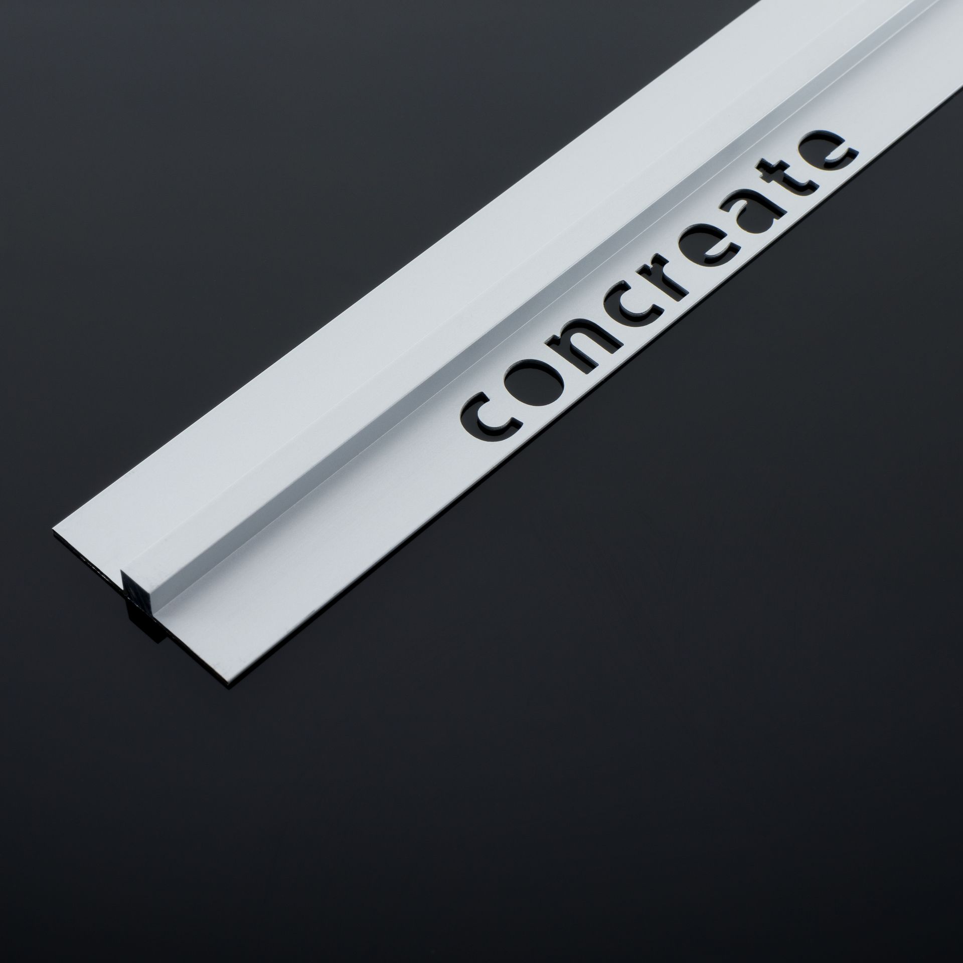 Angled, silver-colored metal trim labeled