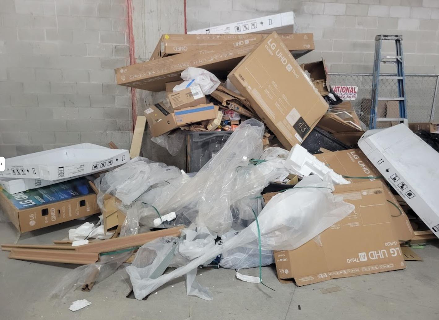 A pile of cardboard boxes sitting on top of each other in a room.