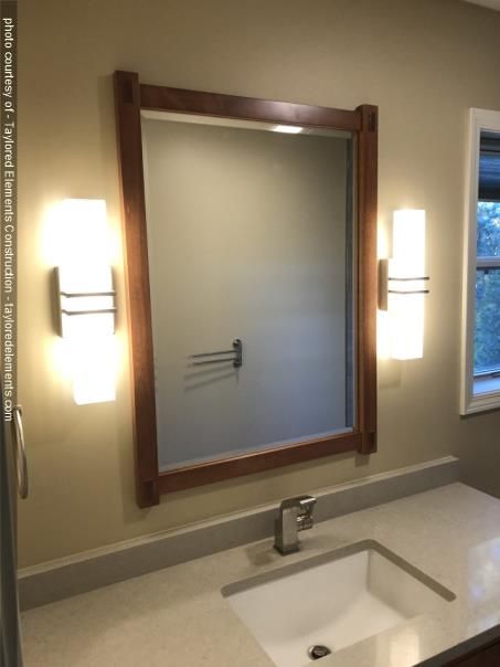 A bathroom with a sink and a large mirror