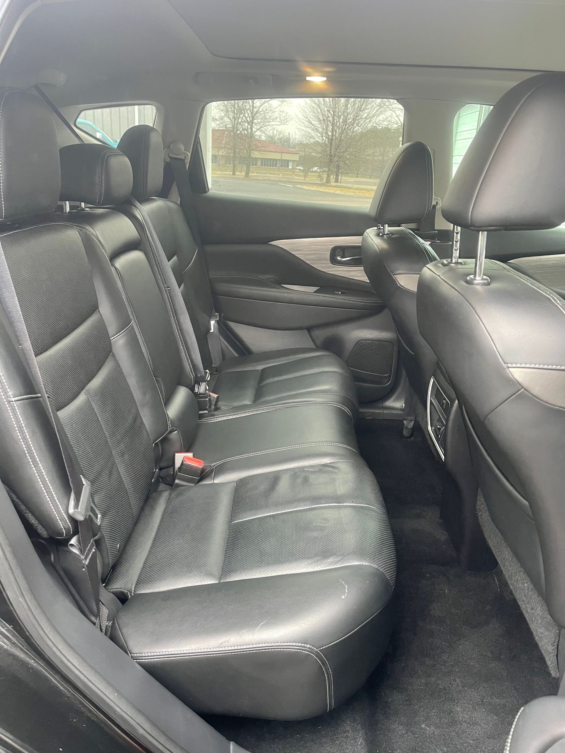 Black leather car back seats with headrests.