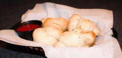 Basket of garlic knots with marinara dipping sauce