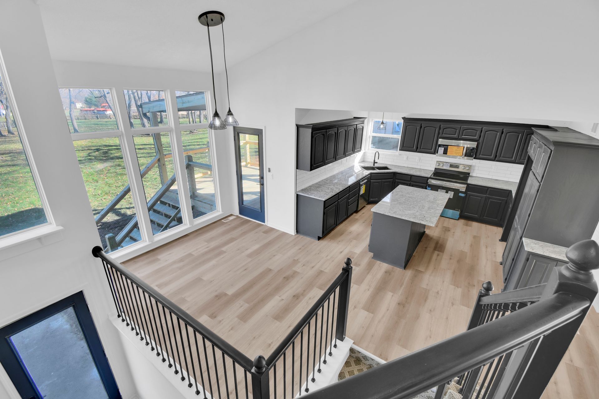 An aerial view of a kitchen and dining room from the second floor.