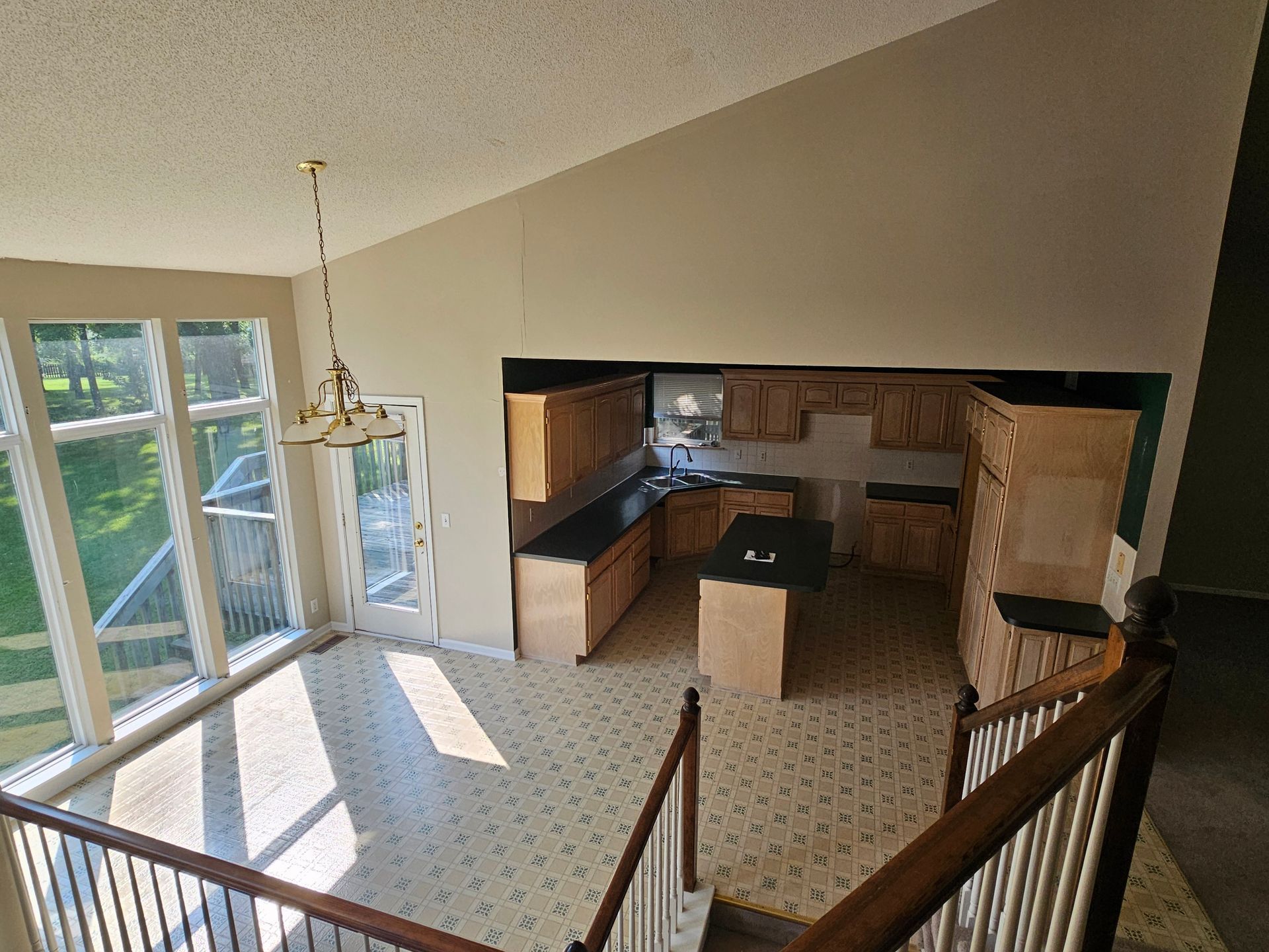 A view of a kitchen from the second floor of a house.