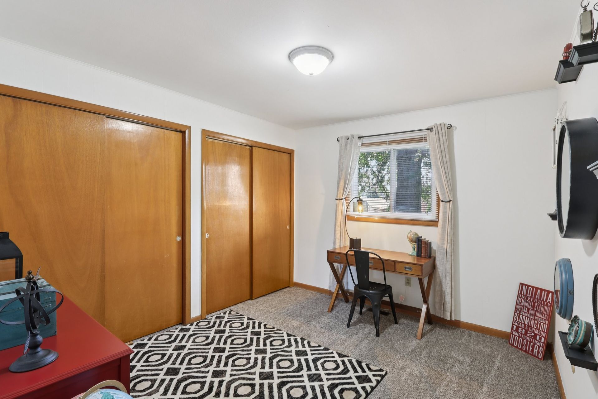 Apartment bedroom with window lighting and closet space at Meadow Park apartments in Bloomington, Indiana