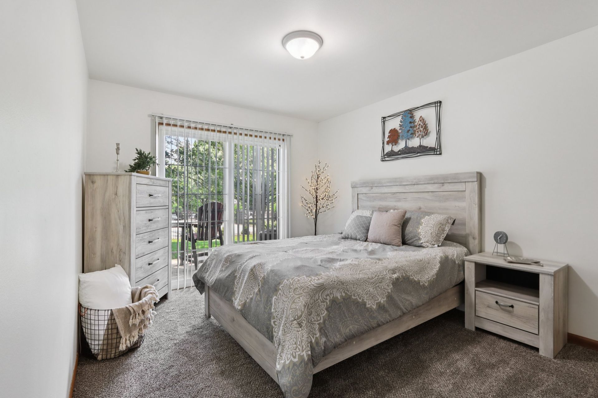 Spacious bedroom with natural light and patio access at Meadow Park apartments in Bloomington, Indiana