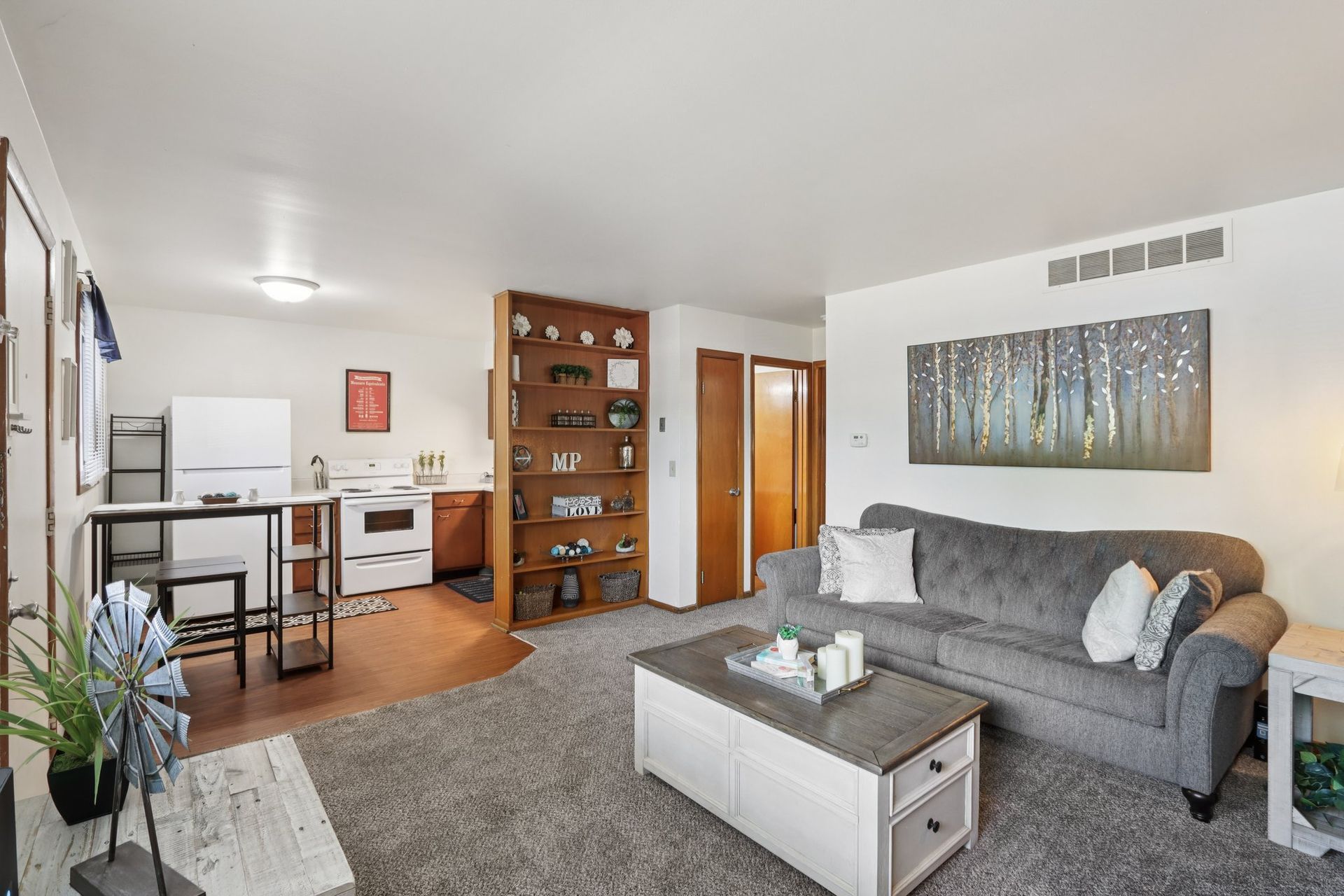 Open-concept apartment with living room and kitchen at Meadow Park apartments in Bloomington, Indiana