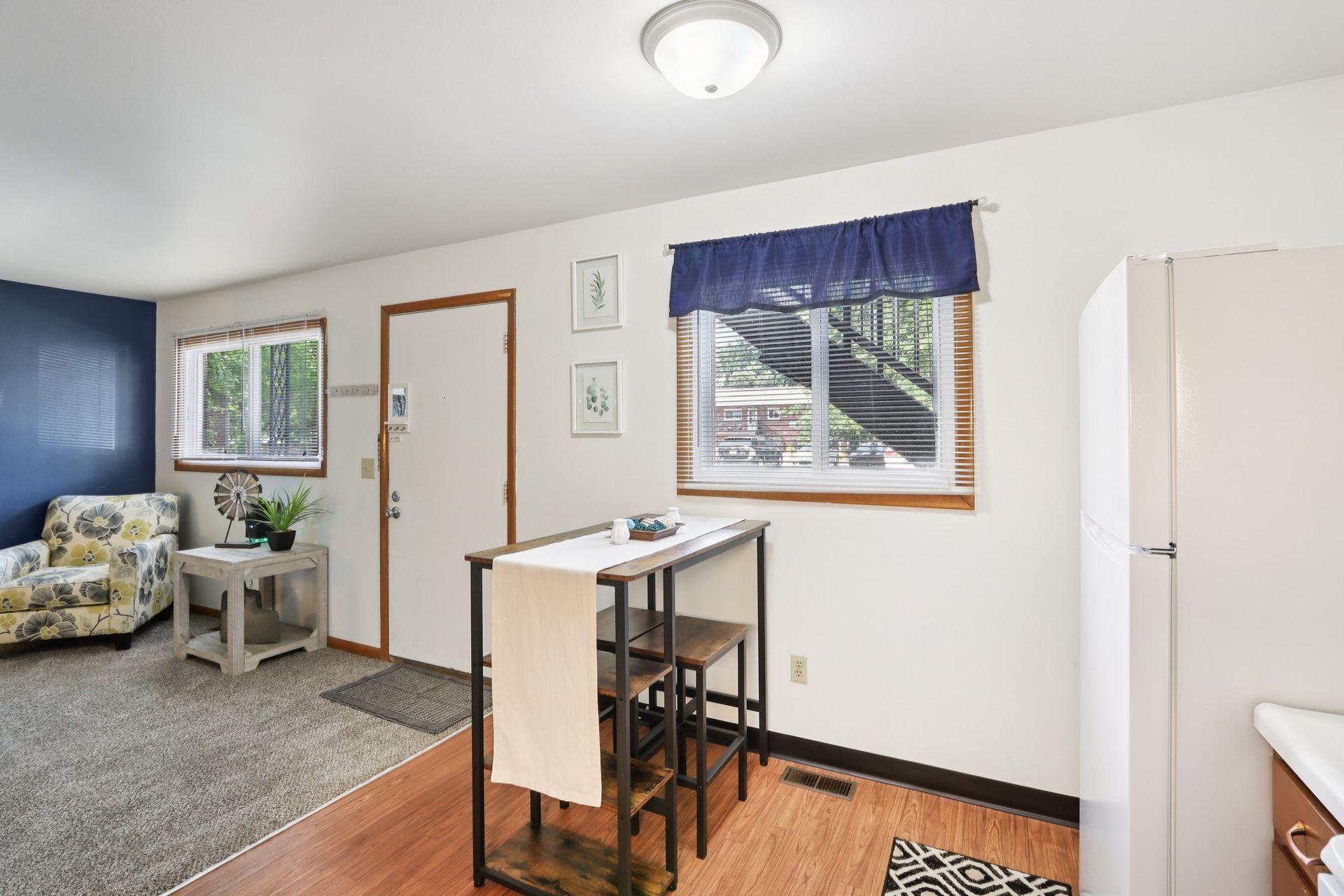Apartment dining area with open living space at Meadow Park apartments in Bloomington, Indiana