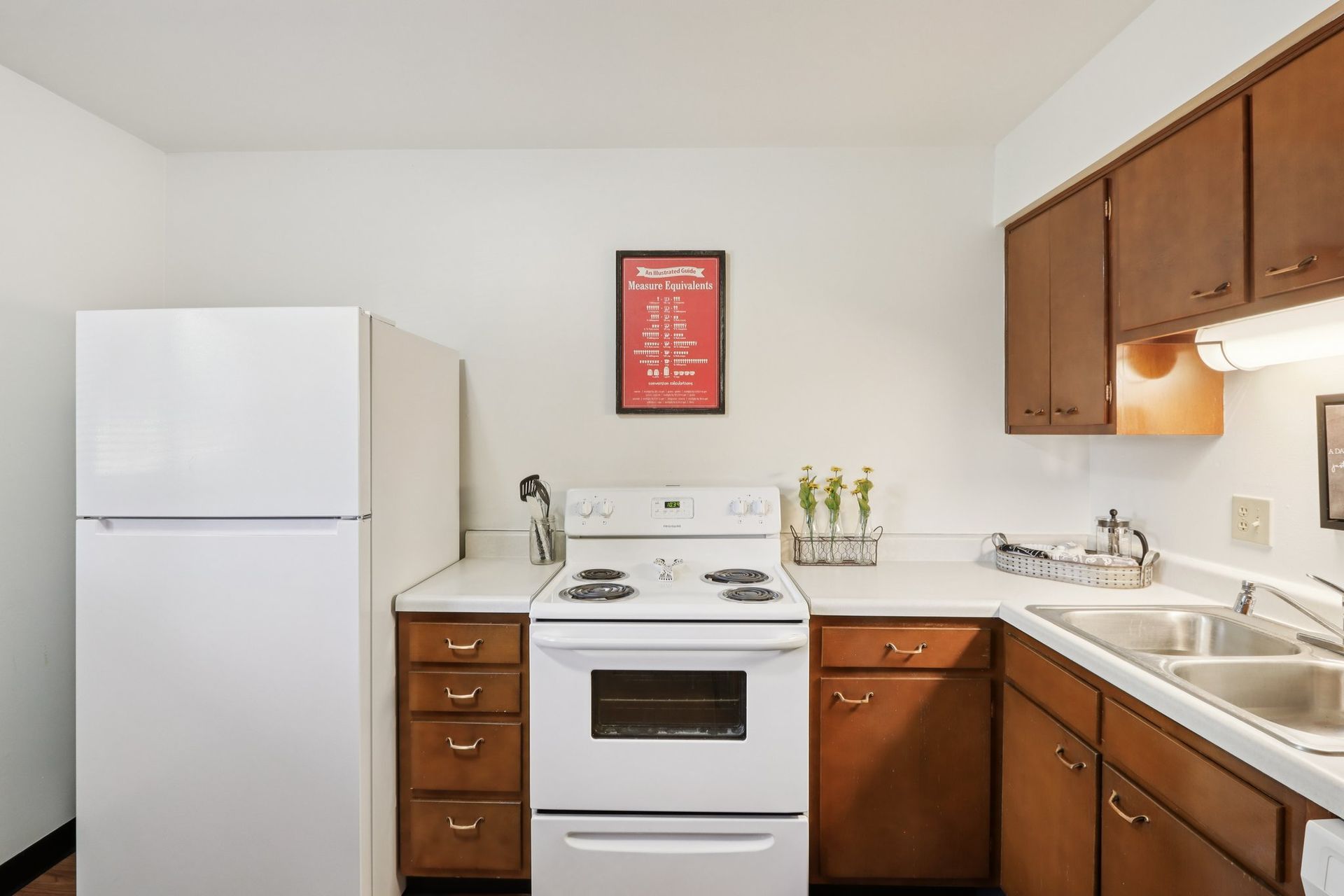 Bright apartment kitchen with ample cabinet space at Meadow Park apartments in Bloomington, Indiana