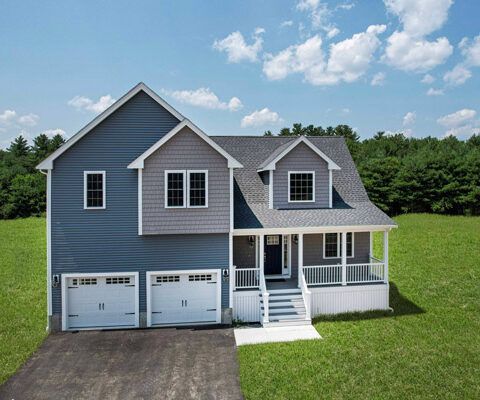 Blue two-story house with white trim, front porch, and two-car garage on a grassy lot under a partly cloudy sky