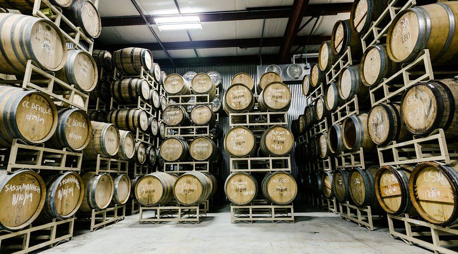 A warehouse filled with lots of barrels stacked on top of each other.