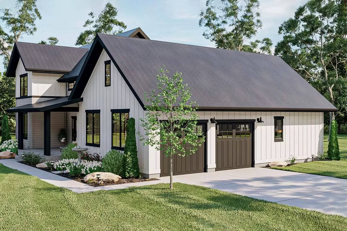Modern house exterior with dark roof, beige siding, garage, and landscaped front yard