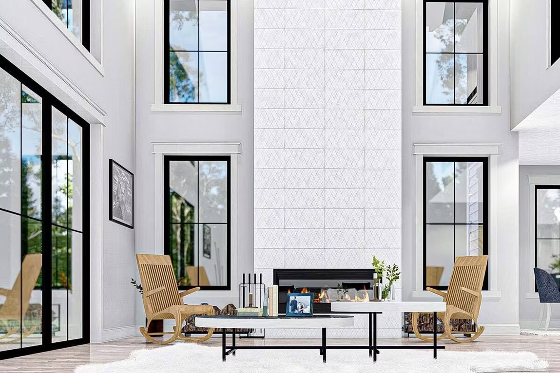 Bright modern living room with white walls, tall windows, tan chairs, and a glass coffee table