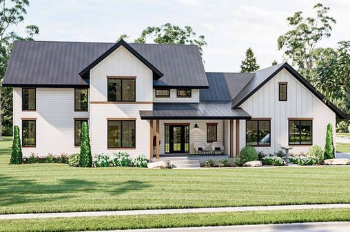 Modern two-story white farmhouse with dark roof and manicured lawn