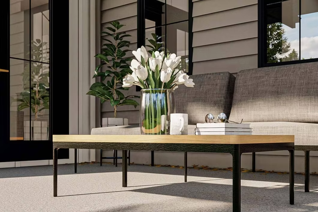 Modern patio seating area with a wooden coffee table, vase of flowers, and beige sofa against sliding glass doors