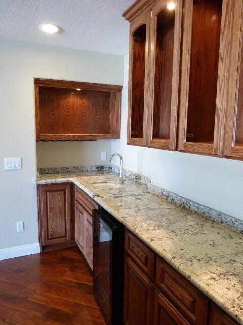Nice kitchen with dark wooden cupboards — Hesperia, CA — Bergstrom Construction
