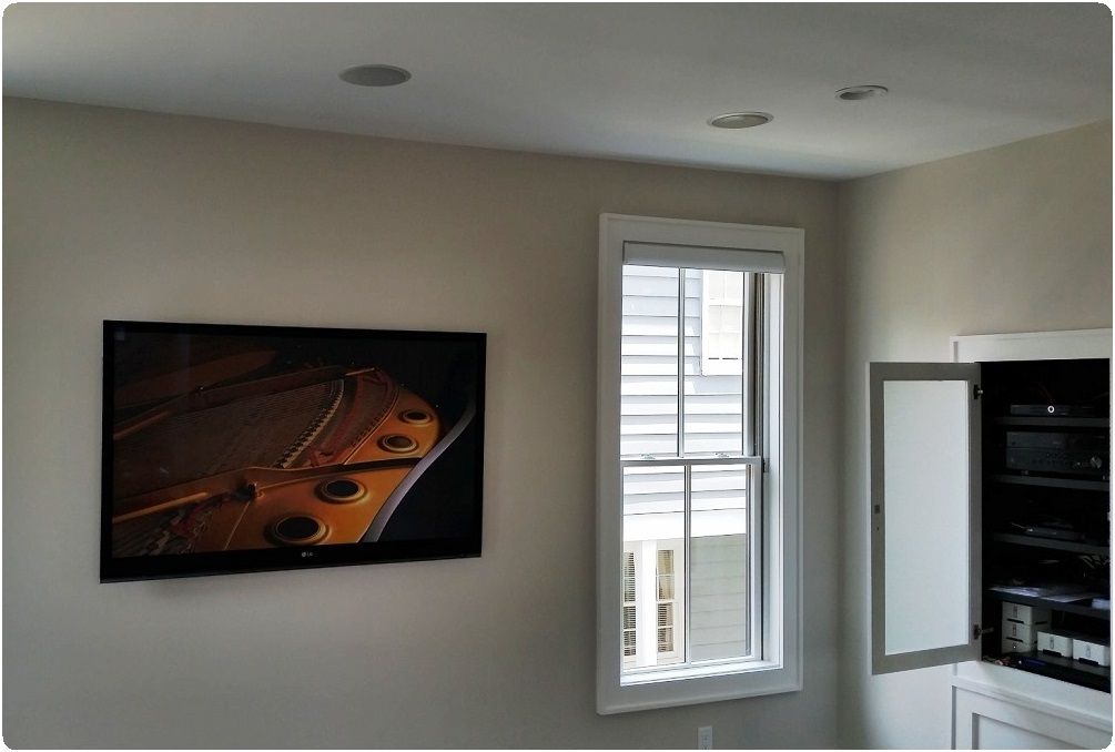 Bright room with framed wall art, a window, and an open cabinet shelf.