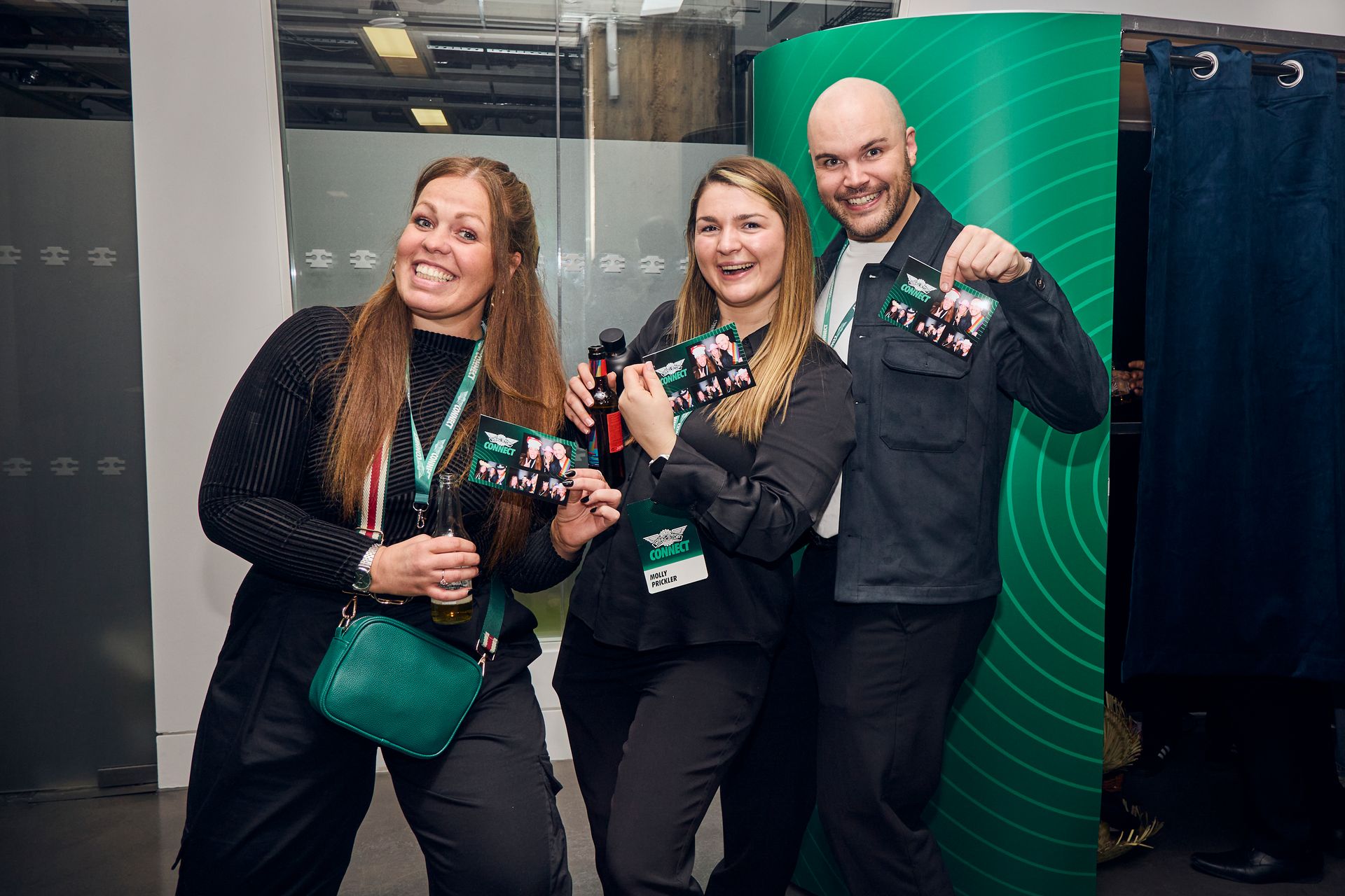 Guests receiving instant prints from enclosed photo booth