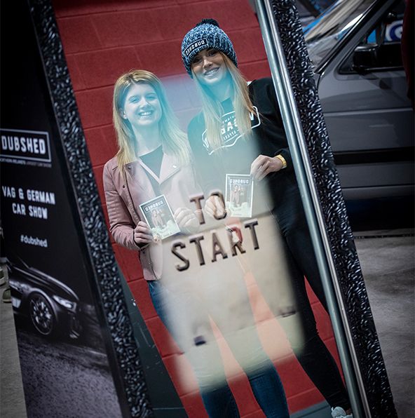 Event guests taking selfies using magic mirror photo booth