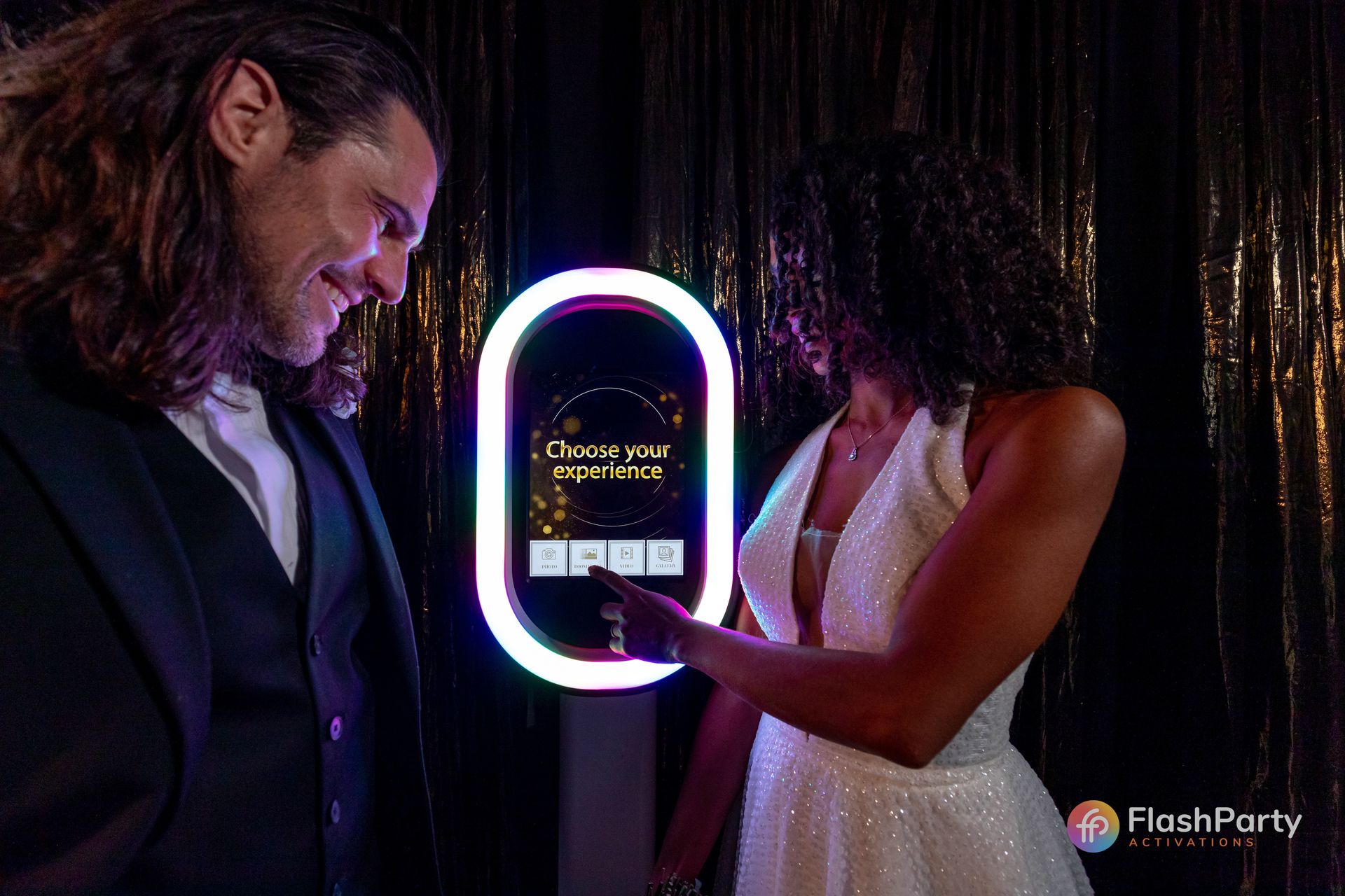 Wedding party guests enjoying interactive wedding photo booth experience