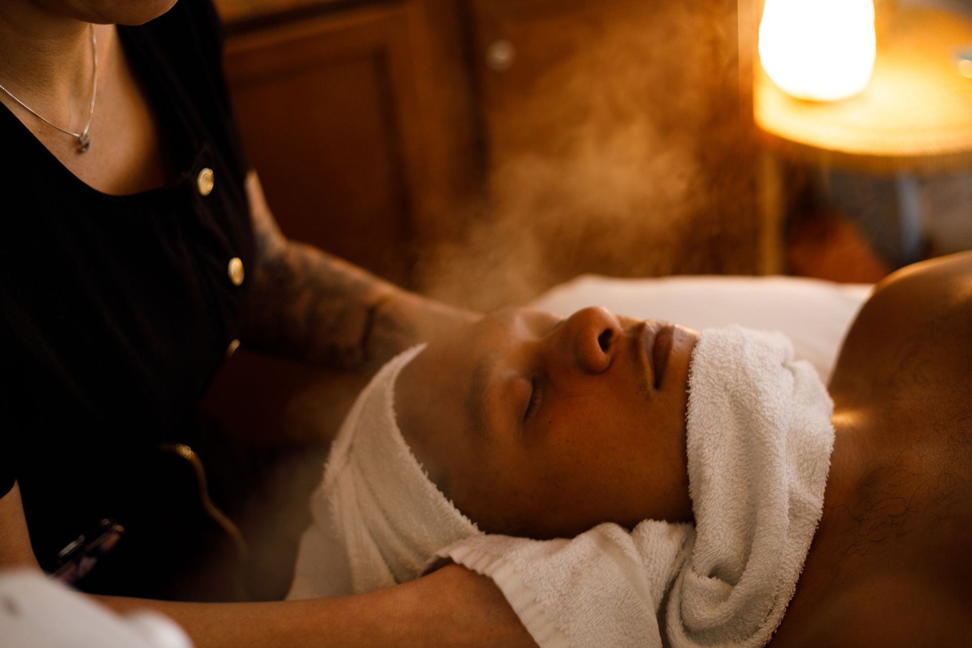 Steaming towels on a face