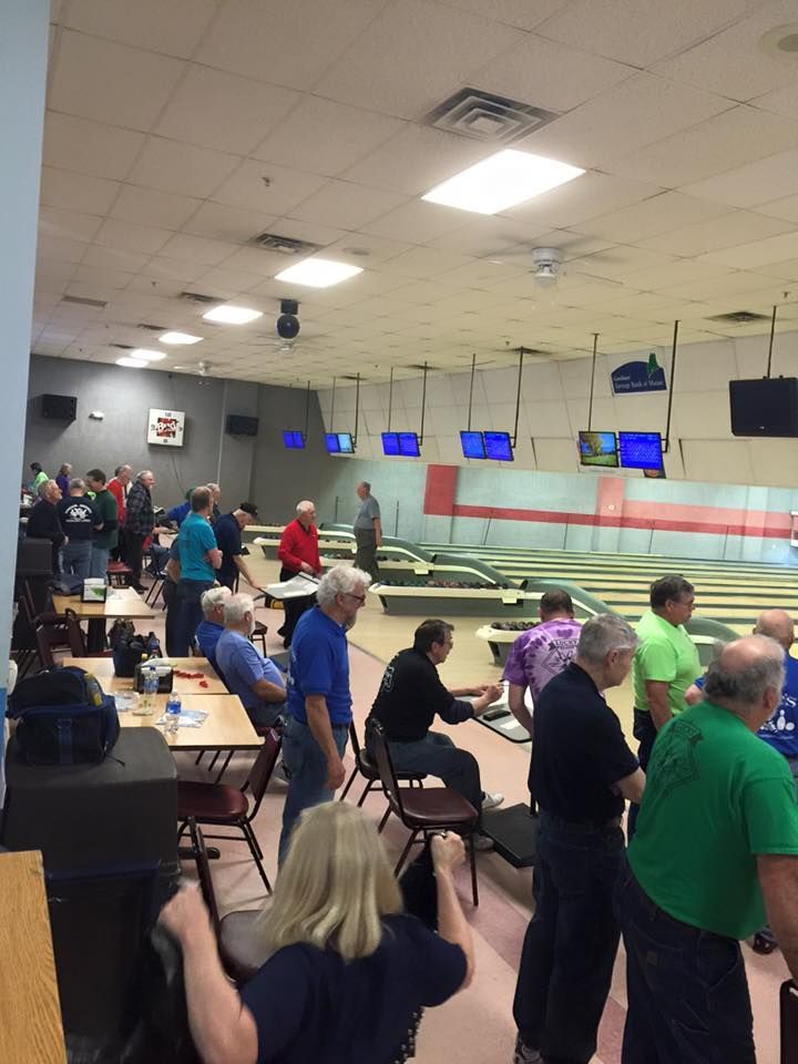 A group of people are gathered in a bowling alley