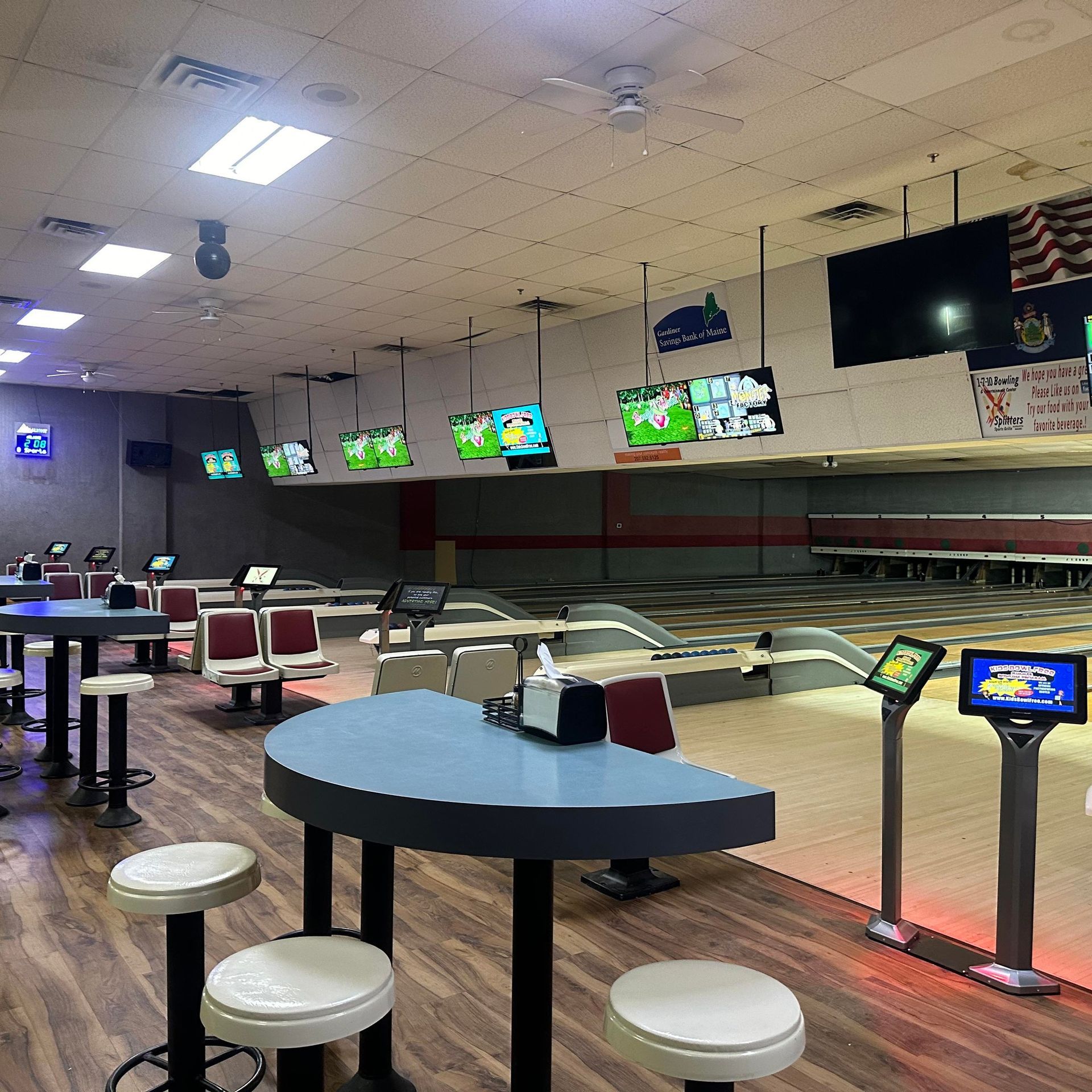 A bowling alley filled with tables and chairs