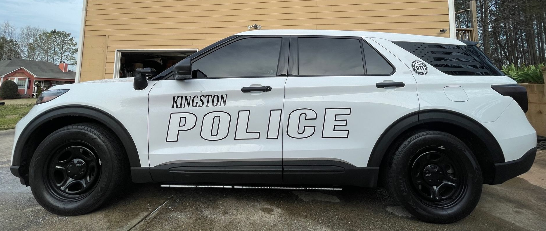 White police SUV parked on a street, marked with 