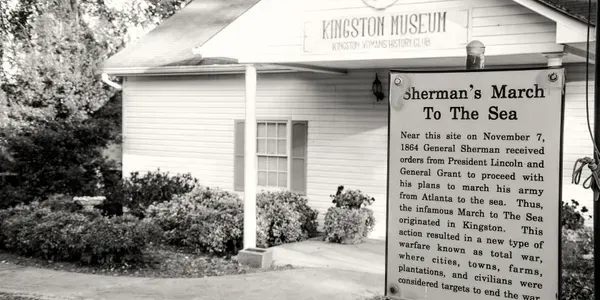 Black-and-white photo of a museum entrance with a sign for “Sherman’s March to the Sea” exhibit.