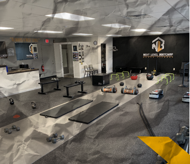 A gym with a sign that says next level bootcamp