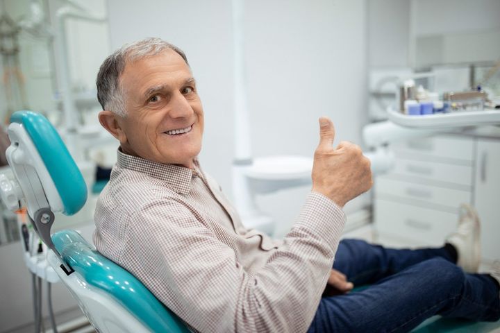 Man Sitting In A Dental Chair — Matthews, NC — Bellasera Family Dentistry Man Sitting In A Dental Chair — Matthews, NC — Bellasera Family Dentistry