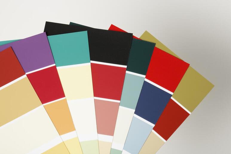 Fan of overlapping color swatches showing a range of bright paint colors