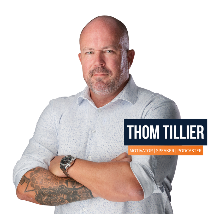 A man named Thom Tillier is standing with his arms crossed
