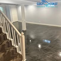 Staircase leading to a basement with metallic gray epoxy flooring and white walls.