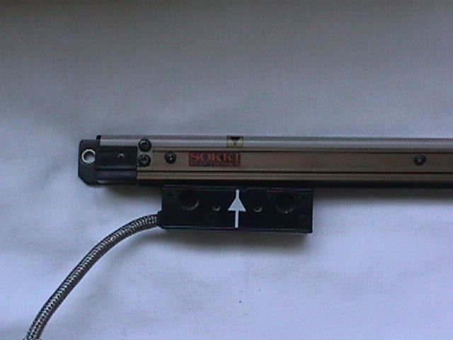 Metal drawer slide with a black bracket and white arrow on a light background